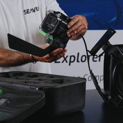 Seavu Explorer Adventure Kit showing underwater camera housing, media cable, and phone displaying live video