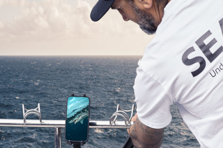 Fishing camera mounted on an extension pole, showing live underwater footage on a phone via Seavu kit