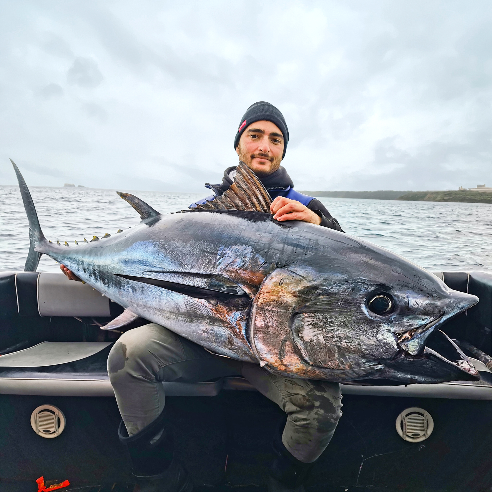 Chris Cassar from Cassar Fishing Charters holding a large bluefin tuna, endorsing Seavu for trolling insights