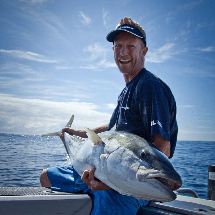 Matt Watson from Ultimate Fishing holding a kingfish, endorsing Seavu underwater camera system