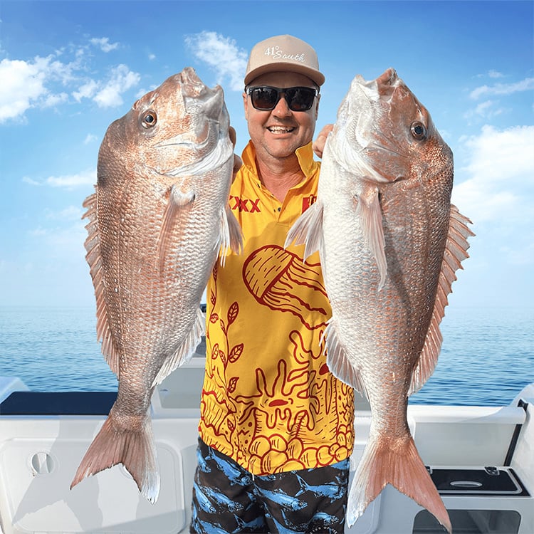 Paul Worsteling from iFish holding two snapper, endorsing Seavu underwater fishing camera system