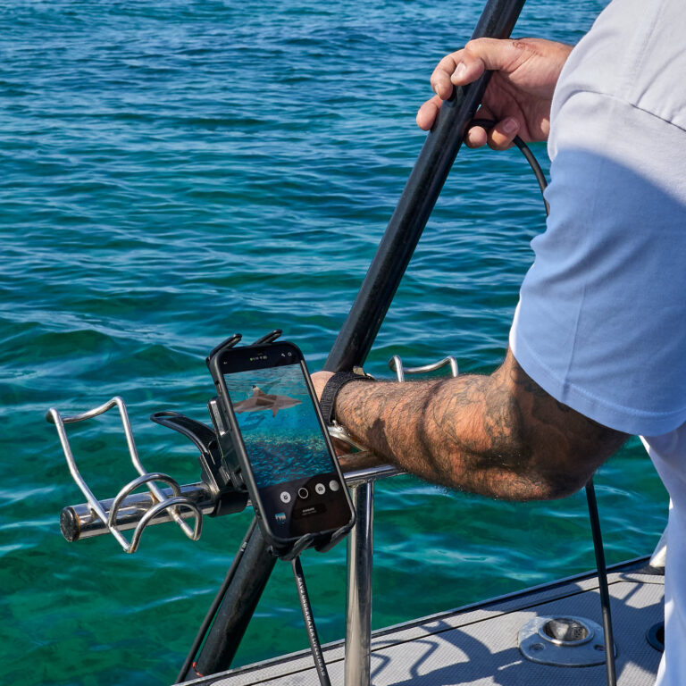 Phone connected to Seavu Seeker Pole Mount showing live underwater footage of a shark