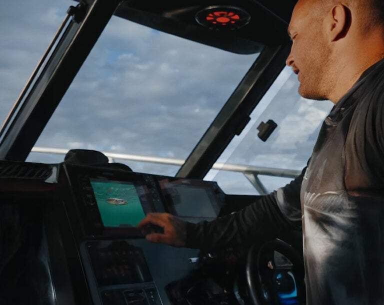 Person viewing live underwater fish footage on a Simrad display using the Seavu Explorer+ system