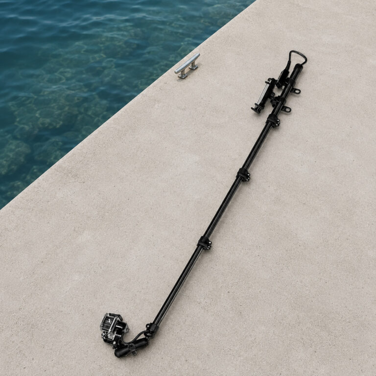 Seeker Pole Kit laid on a concrete pier beside clear water, showing the pole mounted camera system and phone mount.