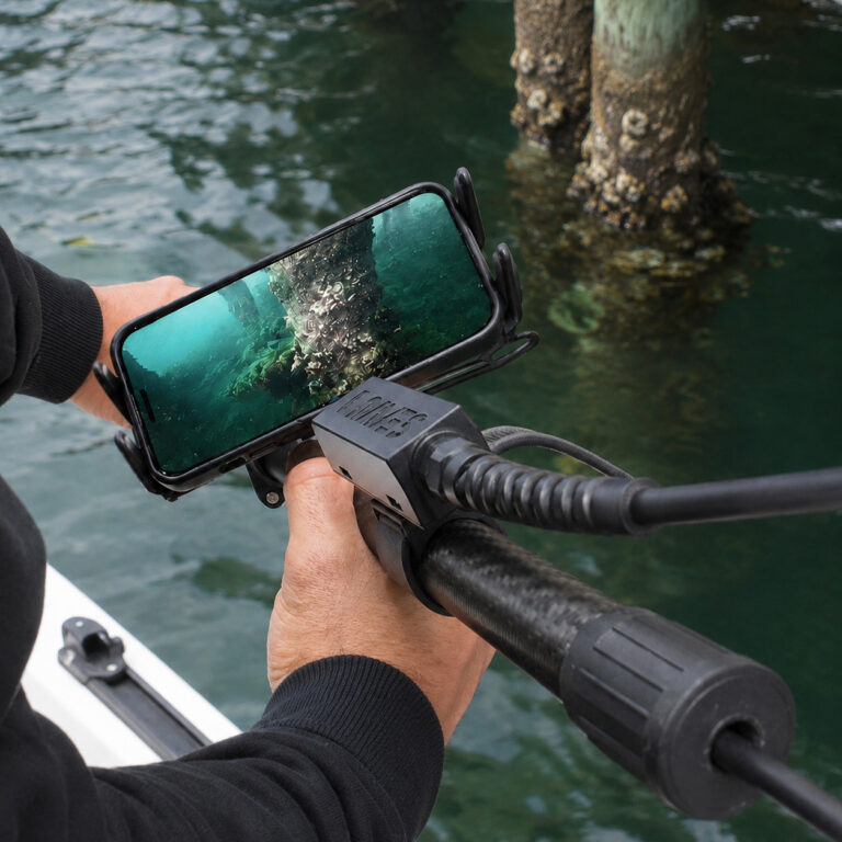 Seeker Pole Kit being used for live underwater marine inspection from a boat with footage displayed on a phone.