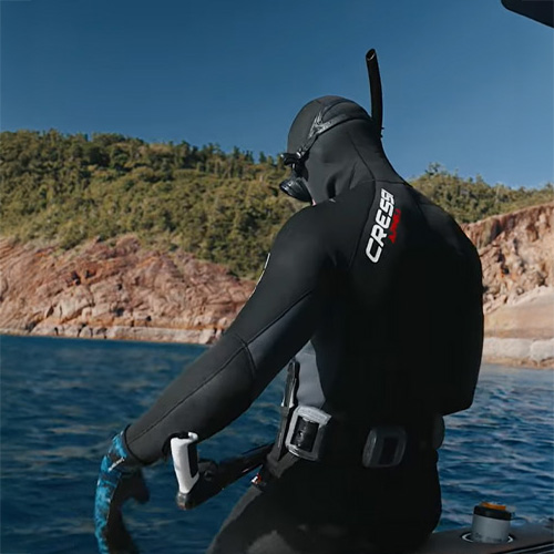 person preparing to dive from boat using live underwater diving camera
