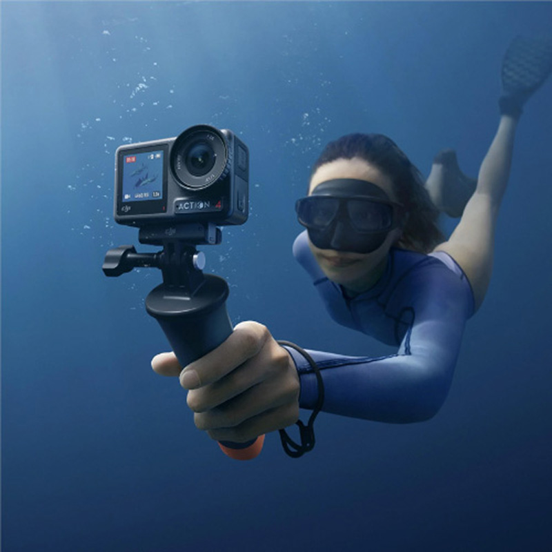 Woman underwater filming with the DJI Osmo Action 4 on a selfie stick, one of the best underwater cameras compatible with Seavu kits.