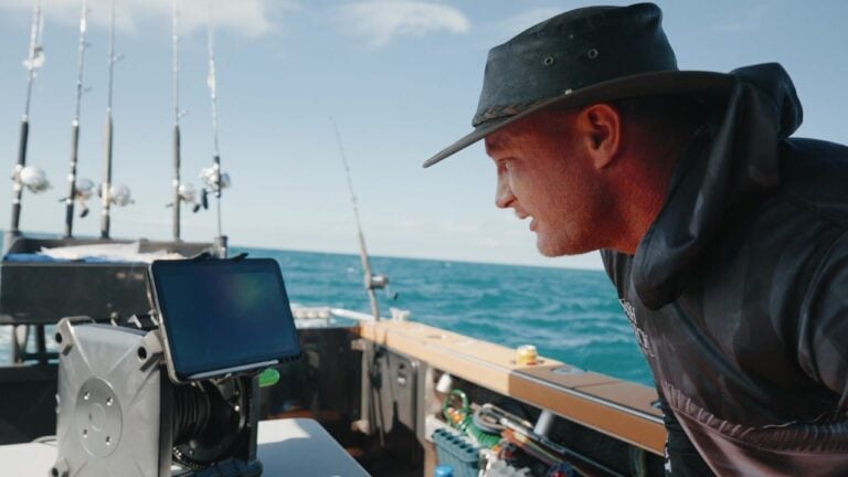 People fishing for Spanish mackerel on a boat while viewing live underwater footage through the Seavu camera system