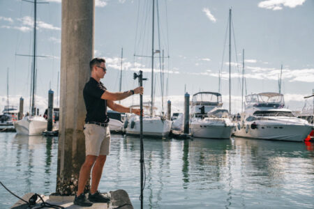 Seavu carbon fibre camera pole extended into a saltwater marina beside moored boats