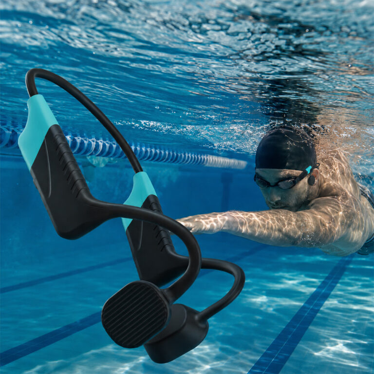 Swimmer wearing the Seavu Swim Coaching Audio System headset while swimming underwater in a pool